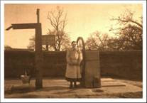 The Square with village pump and girl